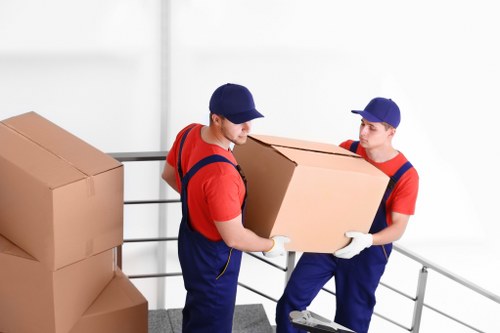 Trained movers assessing safe access and lifting procedures at a property