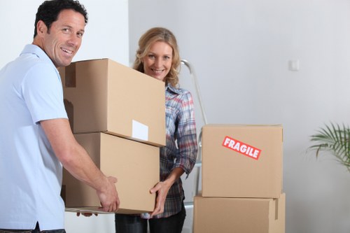Professional movers handling desks and office furniture during a Harrow relocation